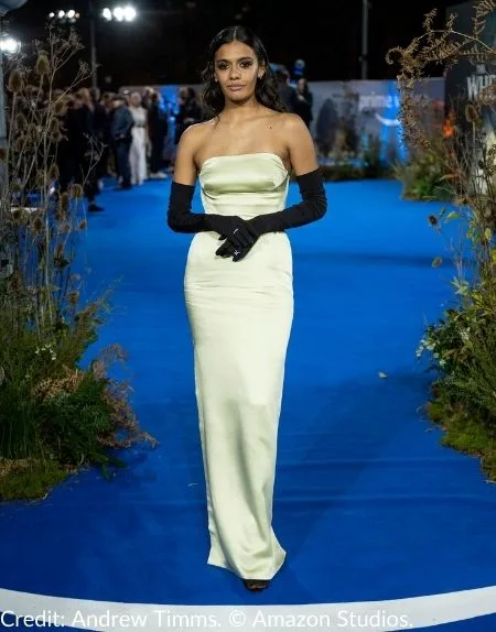 Madeleine Madden, who plays Egwene al’Vere in The Wheel of Time, graces the blue carpet at the premiere in London, wearing a sleek white gown paired with elegant dark gloves.