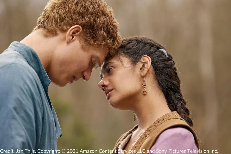 Rand and Egwene gently press their foreheads together, eyes closed, in an emotional moment outdoors.